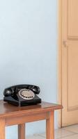 Captivating Vintage Rotary Telephone on a Rustic Wooden Table, Evoking Nostalgia for Classic Communication and Timeless Home Decor. photo