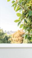 Vibrant green leaves frame a serene outdoor view with soft natural light, overlooking a tranquil blurred city skyline from a peaceful vantage point. photo