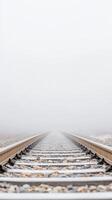 Ethereal train tracks disappear into a dense winter fog, evoking a sense of tranquil mystery and endless journey through a monochromatic, silent landscape. photo