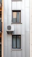 Modern Urban Facade Sleek Architectural Detail with Windows and Air Conditioning Unit on a Contemporary Building Exterior, Reflecting Urban Living. photo