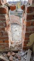 Crumbling Brick Wall A Detailed Study of Architectural Decay, Revealing Raw Textures, Historic Masonry, and Urban Abandonment. photo