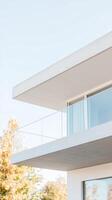 Striking Modern Architecture Concrete and Glass Balcony with Autumn Foliage Under a Bright Sky. Contemporary Building Design photo