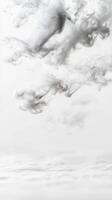 Ethereal white and grey smoke swirls gracefully on a pristine background, creating an abstract, flowing texture perfect for serene designs and concepts. photo