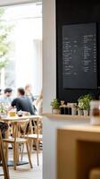 Inviting Cafe Interior with Patrons Enjoying a Relaxed Atmosphere, Featuring a Stylish Chalkboard Menu and Greenery. photo