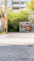 Urban Canvas Sunlit Alleyway with Vibrant Graffiti Art on Weathered Walls and Concrete Textures, Reflecting City Life photo