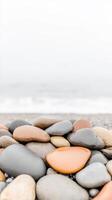 Serene Coastal Pebbles A Close-Up of Smooth, Colorful Beach Stones by the Tranquil Ocean Shoreline, Capturing Nature's Calm Beauty. photo