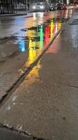 Colorful Urban Reflections Dance on a Wet City Street at Night, Capturing the Luminous Essence of Metropolitan Life After Rain photo
