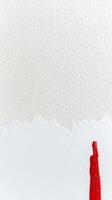Vibrant Red Paint Stroke on Textured White Wall A Modern Abstract Background with Bold Contrast and Artistic Simplicity photo