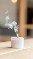 Captivating white candle with dancing flame and ethereal smoke, creating a serene and tranquil ambiance for relaxation and home decor. photo