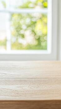 Elegant wooden table with a bright, blurred green nature background through a window, perfect for product display or text overlay. Natural light. photo