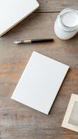 Creative Workspace Flatlay Vintage Pen, Blank Notebook, and Paint Jar on Rustic Wooden Desk. Ideal for Art, Writing, and Design Projects photo