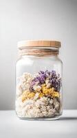Aesthetic Dried Flower Arrangement in a Clear Glass Jar with Natural Wooden Lid and Rustic Twine Detail, Perfect for Elegant Home Decor. photo