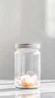 Delicate Dried Flower Petals in a Clear Glass Jar A Minimalist Botanical Still Life Capturing Serene Light and Gentle Reflections photo