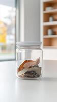 A minimalist still life capturing dried bay leaves in a clear glass jar on a pristine white kitchen counter, evoking culinary simplicity and natural aroma. photo