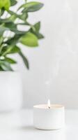 Tranquil White Candle with Soft Flame and Ethereal Smoke, Illuminated by Natural Light, Enhancing Peaceful Home Ambiance and Mindful Relaxation photo