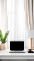 Sleek Home Office Interior A Modern Workspace Featuring a Laptop, Lush Greenery, and Soft Natural Light for Focused Productivity photo