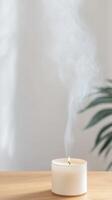 Elegant White Scented Candle with Dancing Flame and Rising Smoke on a Warm Wooden Surface, Perfect for Tranquil Home Decor and Relaxation. photo