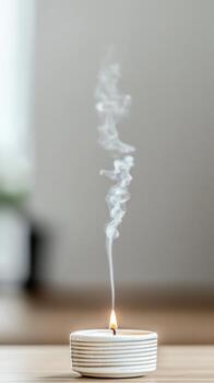 Captivating image of a lit candle with delicate smoke rising, creating a serene and peaceful atmosphere for relaxation, meditation, and cozy home decor. photo