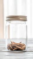 Elegant glass jar filled with delicate dried botanical elements, showcasing natural textures and warm earthy tones in a sunlit, minimalist setting. photo