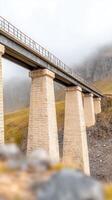 Majestic Stone Viaduct Spanning a Foggy Mountain Valley An Architectural Marvel Amidst Serene, Rugged Highlands, Evoking Grandeur and Connection photo