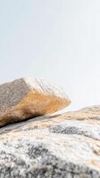 Abstract close-up of weathered granite boulders under a bright sky, showcasing natural rock textures and earthy tones for a serene landscape background. photo