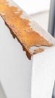 Close-up of vibrant orange rust on a weathered concrete structure, showcasing the intricate textures of material decay and industrial aging. A study in natural corrosion. photo