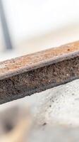 A captivating macro view of a deeply rusted metal beam, showcasing intricate textures and the rich, earthy tones of corrosion, a testament to time's embrace. photo