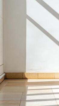 Sunlight and Shadows Dance on a Modern Interior Wall and Tiled Floor, Creating Abstract Geometric Patterns in a Serene Space. photo