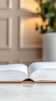 Open Book on a Serene Table A Symbol of Knowledge, Learning, and Quiet Contemplation in a Bright, Minimalist Setting photo