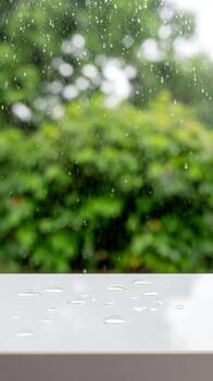 Serene Raindrops on a Pristine White Surface with a Lush Green Bokeh Background photo