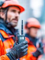 Man Communicates With Walkie-Talkie During Teamwork Activity in a High-Stakes Environment Showing a Sense of Urgency and Collaboration photo