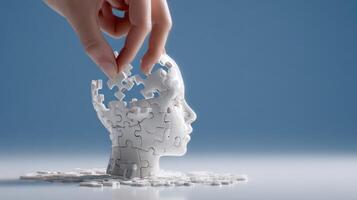 Hand placing puzzle piece in a white 3D head photo