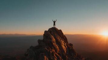 Man atop mountain at sunset photo