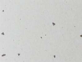 Light Gray Textured Background with Small Scattered Triangular Inclusions photo
