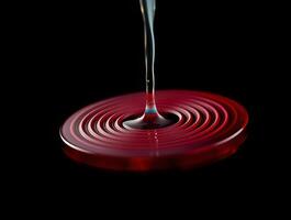 A red liquid being poured into a circular object photo