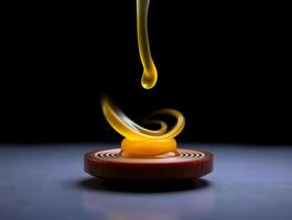 A yellow liquid dripping from a candle on a table photo