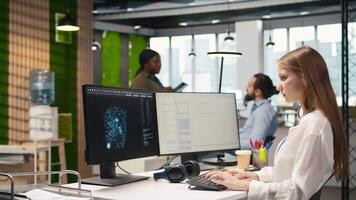 Junior dev testing machine learning algorithms and listening music at work. Young woman wearing headphones scaling productivity with AI large language model written code, camera A video
