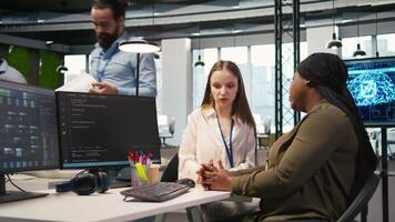 Friendly office senior mentor helping stressed intern at work, giving wise advice. Empathic manager at desk listening to fatigued worker suffering from burnout, giving motivational support, camera A video