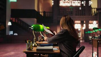 Older woman asking colleague for new study materials to highlight with a colorful pen, study strategy to better memorize essential information. Female student at the university library. Camera A. video