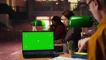 focalizzata anziano uomo lettura accademico testo con croma chiave su pc a il Università, seduta nel Vintage ▾ studia la zona e navigazione in linea corsi. conoscenza e ambizione. telecamera un. video