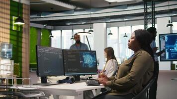 Female admin using AI neural networks tech on computer to optimize performance and forecast issues. Woman in office training artificial intelligence deep learning models using PC, camera A video