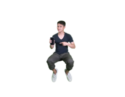 A young man dressed casually in a squatting pose, showing a promotional app smartphone. png