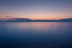 Serene Sunset over Calm Ocean Waters photo