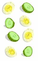 Cucumber slices and boiled eggs sprinkled with black pepper vector