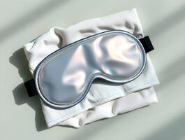 A white sleep mask with a silver frame photo