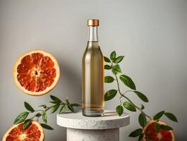 A bottle of olive oil with grapefruit slices on a table photo