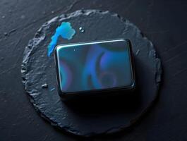 A square black box with blue paint on it photo