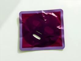 A purple and purple sheet of paper with a face mask photo