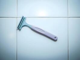 A razor is sitting on a tiled floor photo