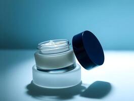A jar of cream on a blue surface photo